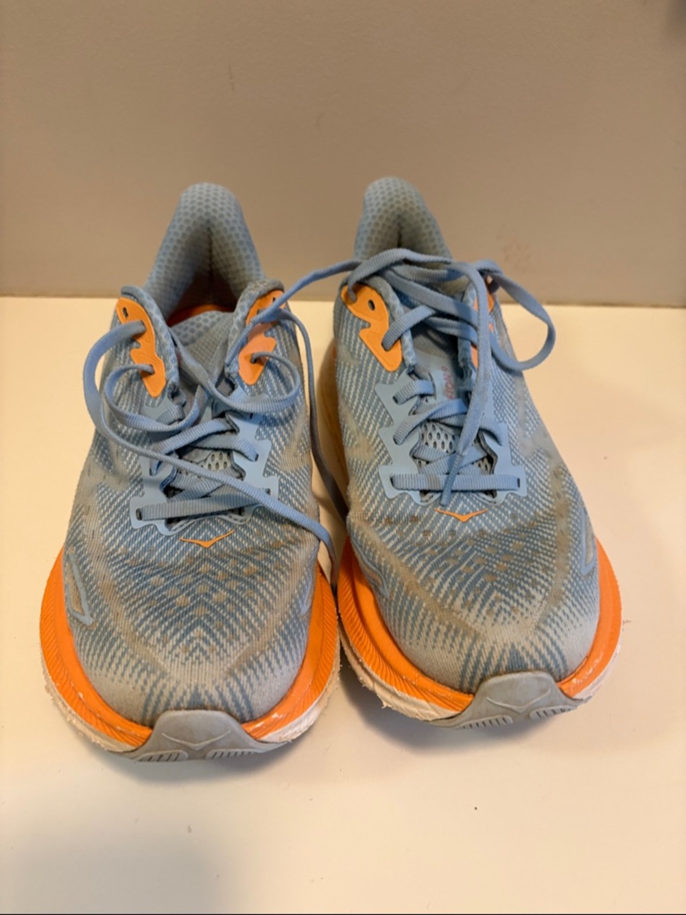 Hoka light blue and orange women's athletic running shoes